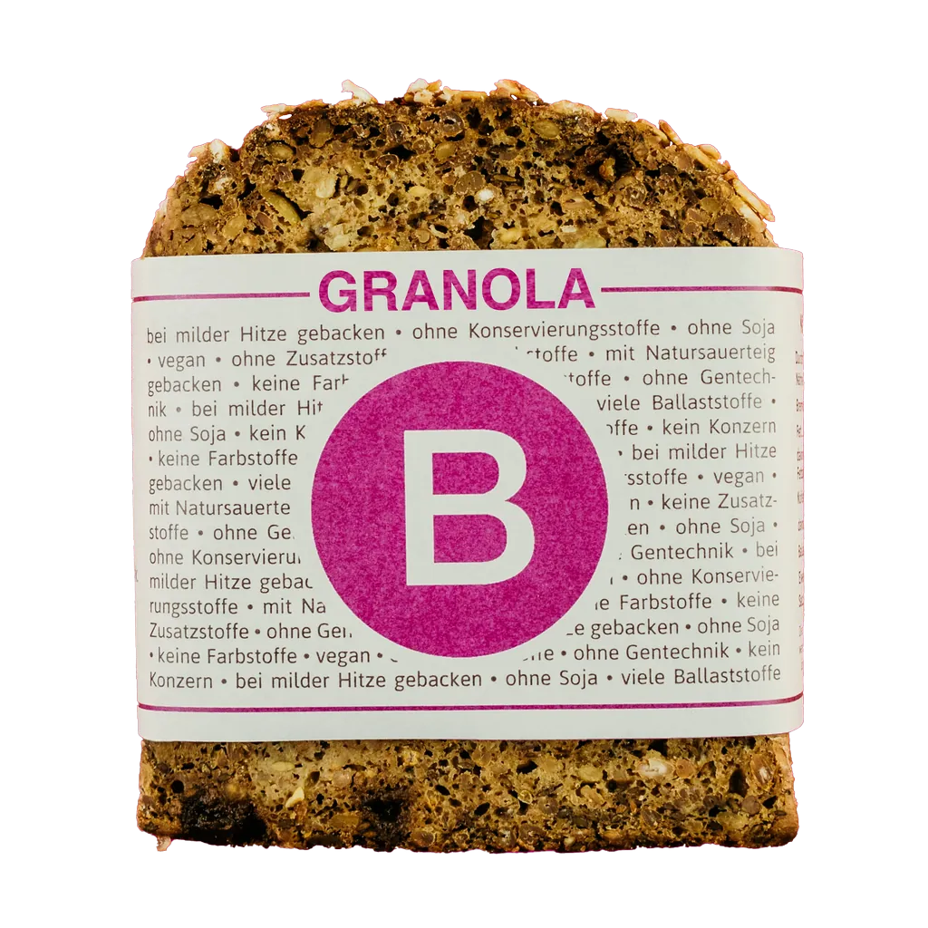 Scheibe B. Just Bread „GRANOLA“ mit pinker B-Banderole, Granola-Brot mit Text zu Zutaten und Eigenschaften auf der Verpackung.